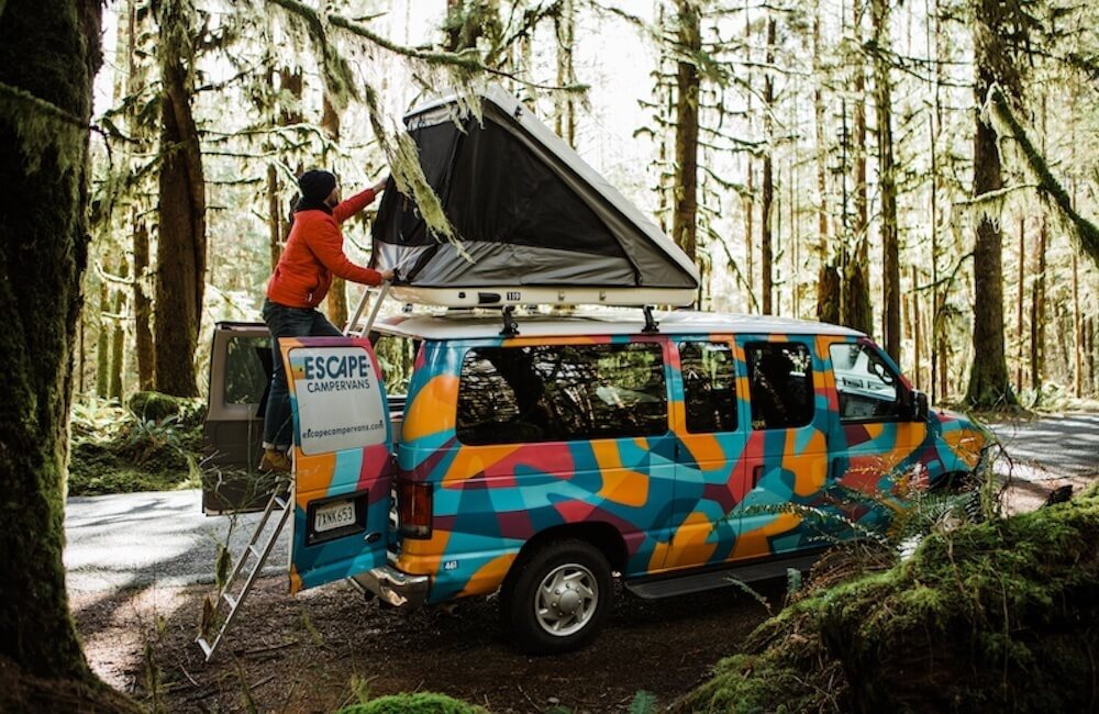 Roof-top storage box with sitting area for a tourist van.