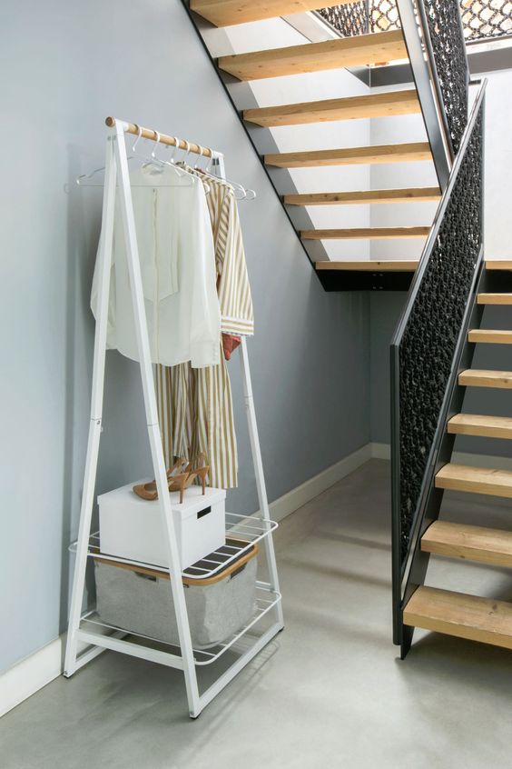 Ladder styled shelving units with hanging and shelving space.