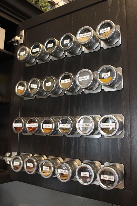 Magnetic strips holding spice containers made of tin.