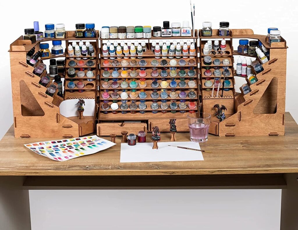 Multi-tiered wooden rack which is also foldable, containing all the painting supplies. 