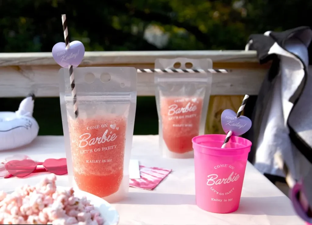 Fun barbie cups with pink and peach drinks.