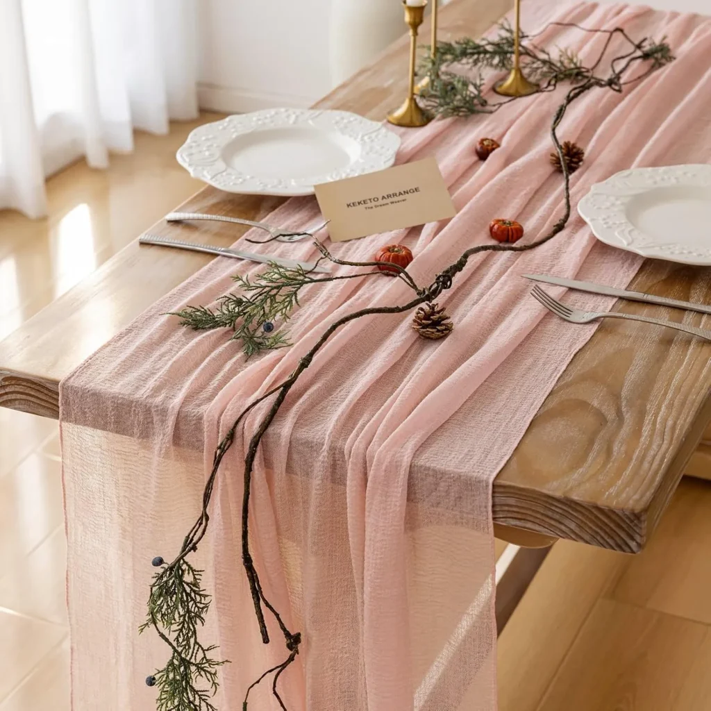 Pink chiffon table runner with a faux dried branch garland..