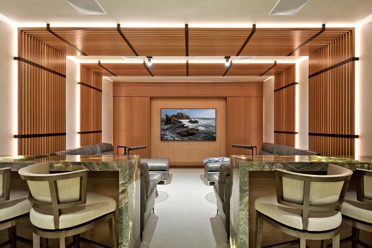 Wood-panelled walls in a very modern theatre room.