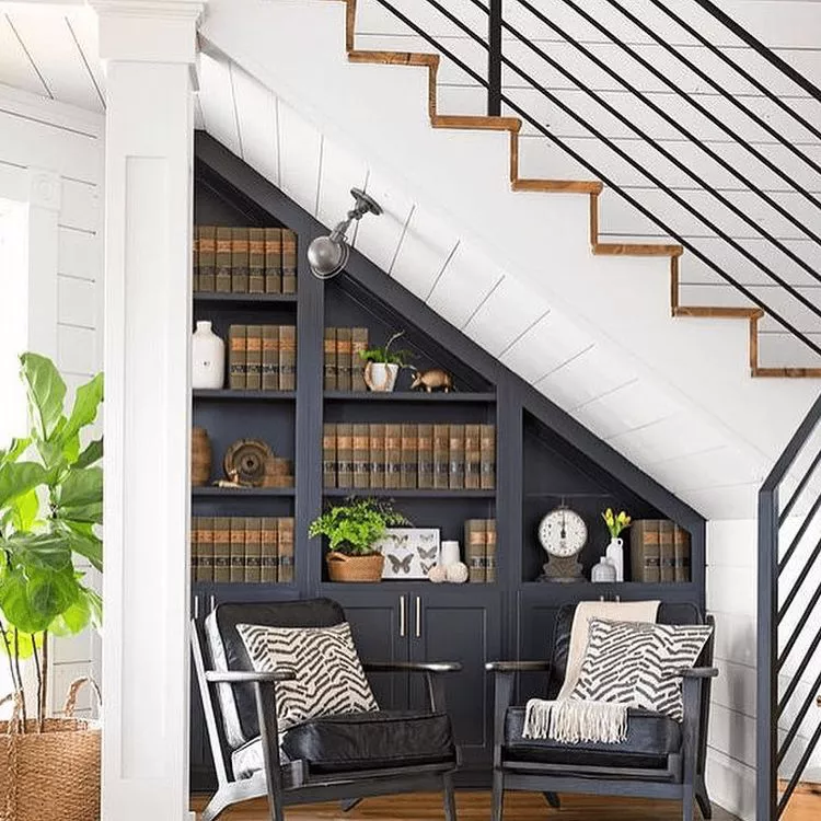 Utilize the space under the stairs for the book rack with 2 comfy sofa set for a personal reading corner.