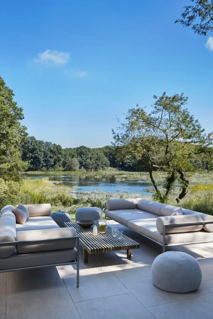 A modern backyard with the panoramic view of the lake.