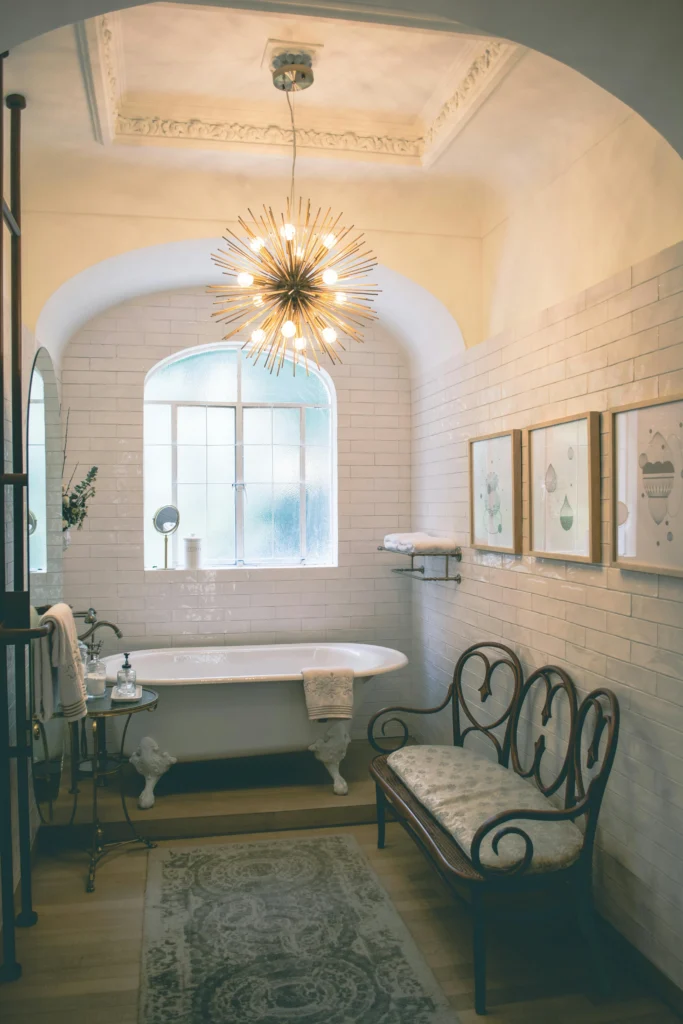 Small bathroom with a sunburst chandelier.