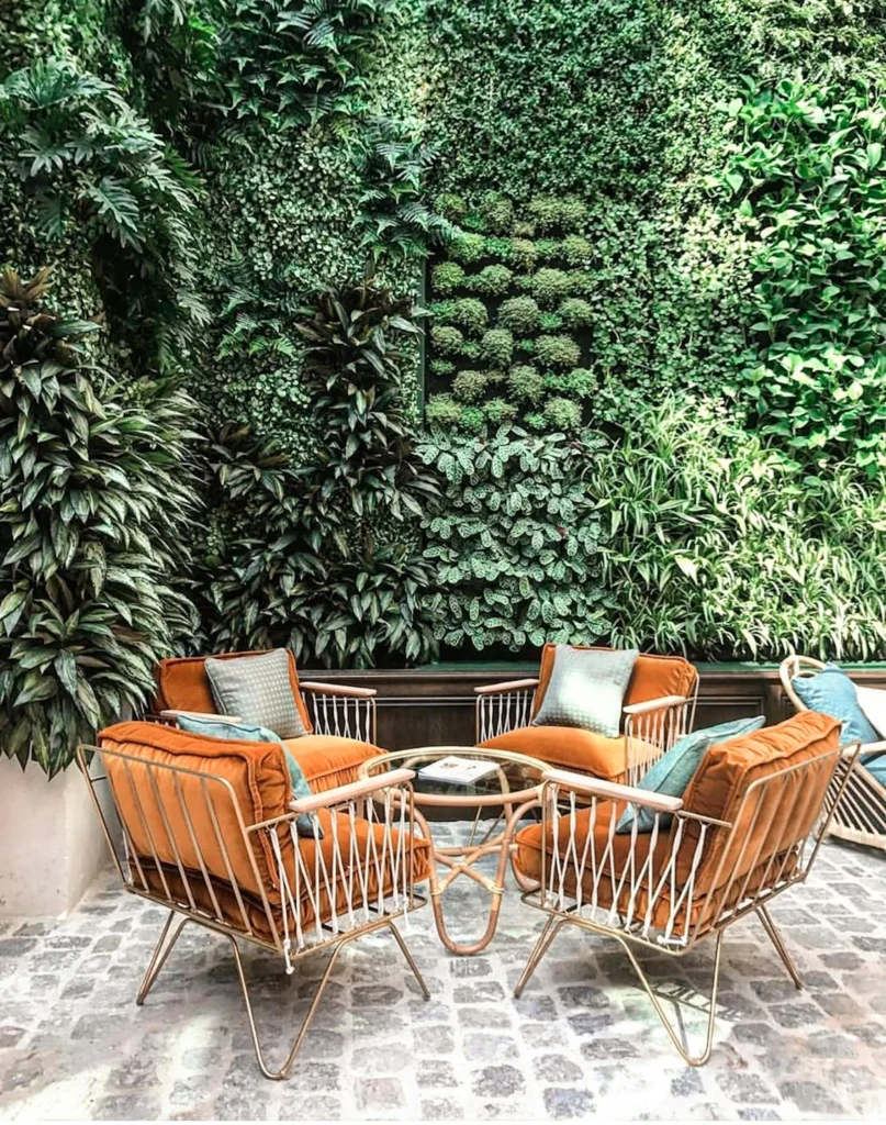 Backyard with minimal furniture and a living wall.